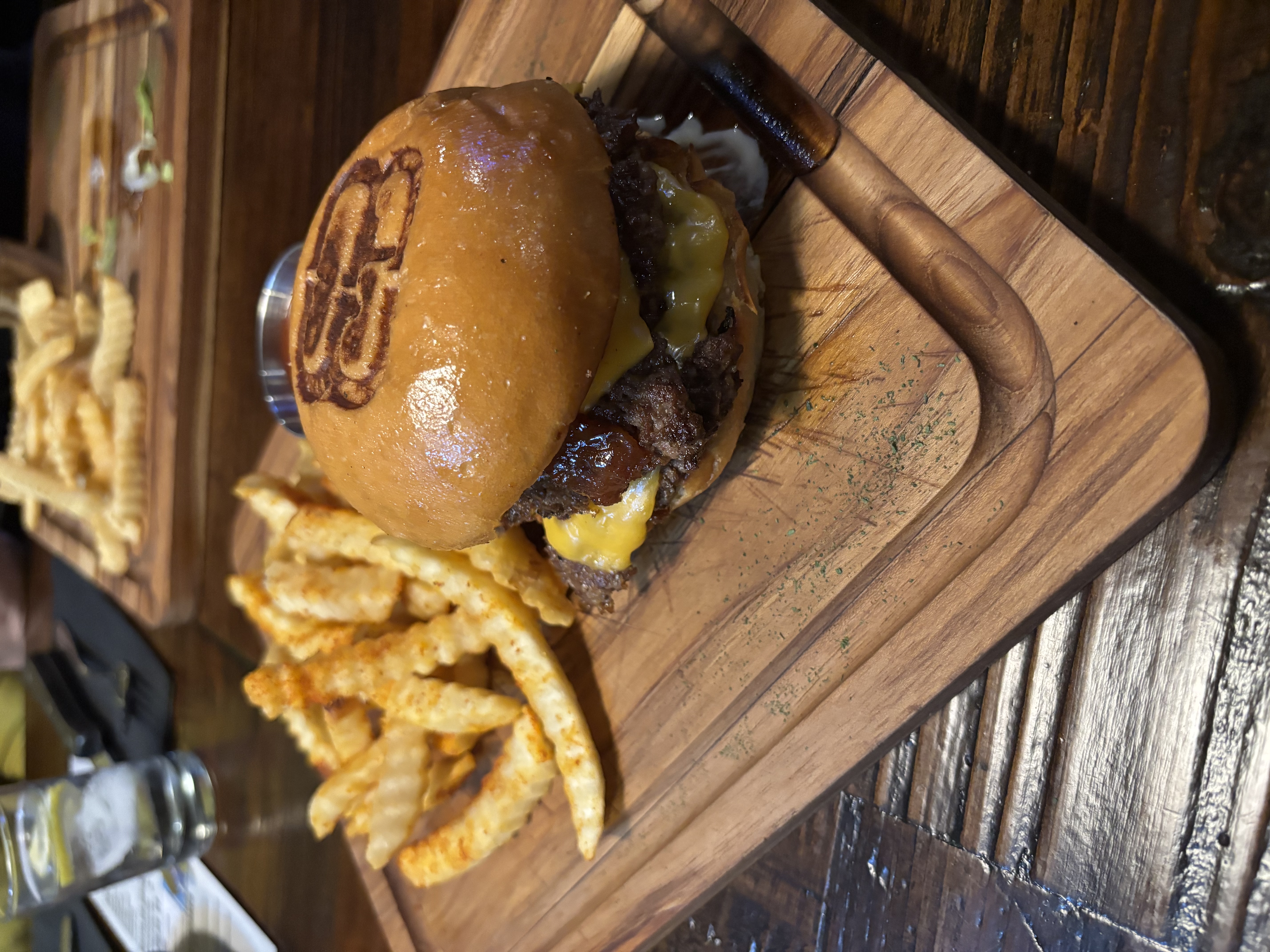 The Project — burger on a wood board with fries